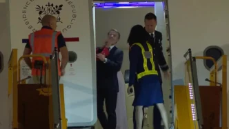 Emmanuel Macron's wife is captured in a viral video shoving him in the face as France's first spouse arrives in Vietnam.